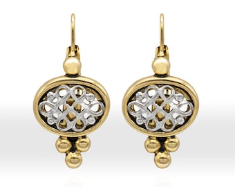May include: A pair of gold-tone earrings with a silver filigree design within an oval frame. The earrings have a lever back closure and three small gold beads at the bottom. The earrings are displayed against a white background.