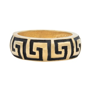 May include: A gold ring with a black Greek key design.