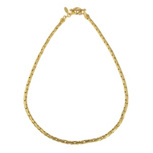 May include: A gold chain necklace with a lobster clasp closure.