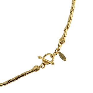 May include: Gold-toned chain necklace with a toggle clasp and a small oval tag with the word "Orvis" engraved on it.