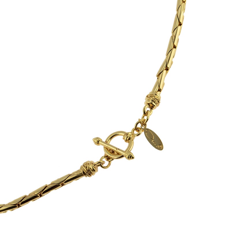 May include: Gold-toned chain necklace with a toggle clasp and a small oval tag with the word "Orvis" engraved on it.