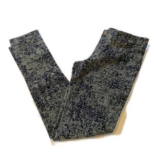 May include: Green and black patterned pants with a dark wash. The pants have a slim fit and a straight leg.