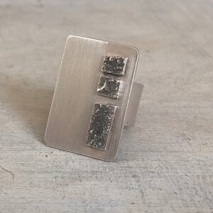 Adjustable Sterling Silver ring with a textured silver stripe design