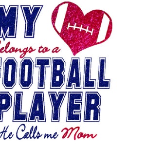 May include: A pink glitter heart with a white football design inside. The text "MY Belongs to a FOOTBALL PLAYER He Calls me Mom" is written in blue and red glitter.