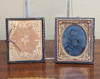 Antique 1800s Daguerreotype photo of a small girl in wooden frame with gold velvet lining frame in 2 pieces