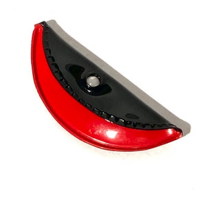May include: A black and red half-circle shaped purse with a white button closure.