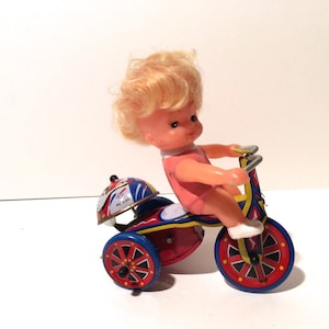 Vintage 1980s Made in Korea Tin Wind Up Doll with Key, Girl on a Trike/Metal Ring A Ling Tin Lithograph Bell Chime Collectible