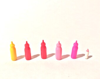 May include: A row of six plastic baby bottles in different colors. The bottles are arranged from left to right in the following order: yellow, red, red, pink, pink, and white.