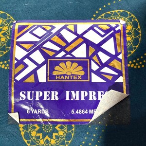 May include: Purple and gold label with the text "SUPER IMPRESS" and "HANTEX" in gold lettering. The label also includes the text "6 YARDS" and "5.4864 MF".