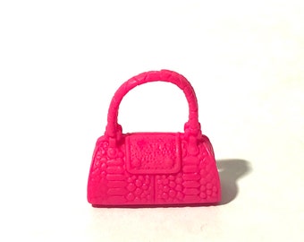 May include: A bright pink plastic handbag with a textured design and a top handle.