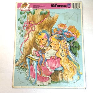 May include: A vintage Lady Lovely Locks frame-tray puzzle. The puzzle features a cartoon illustration of a girl with long blonde hair, a pink dress, and a mirror. The puzzle is extra thick and designed for ages 3 to 7.