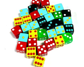 May include: A collection of colorful dice in various colors, including red, yellow, green, blue, and black. Each die features white dots representing numbers. The dice are scattered on a white surface, creating a playful and vibrant arrangement.