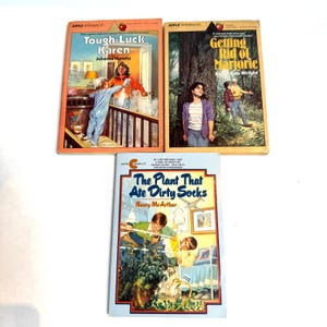May include: Three paperback books with colorful covers. The first book is titled "Tough-Luck Karen" by Johanna Hurwitz. The second book is titled "Getting Rid of Marjorie" by Ron Wright. The third book is titled "The Plant That Ate Dirty Socks" by Nancy McArthur.