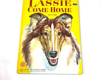 May include: A vintage children's book titled "Lassie Come-Home" by Eric Knight. The cover features a detailed illustration of a collie dog's face against a yellow background. The book is a picture adaptation of the famous story, abridged for young readers.