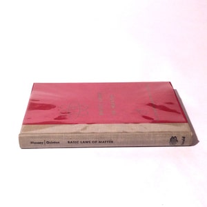 May include: A red hardcover book with a white spine. The spine has the title "Basic Laws of Matter" and the authors "Massey | Quinton".