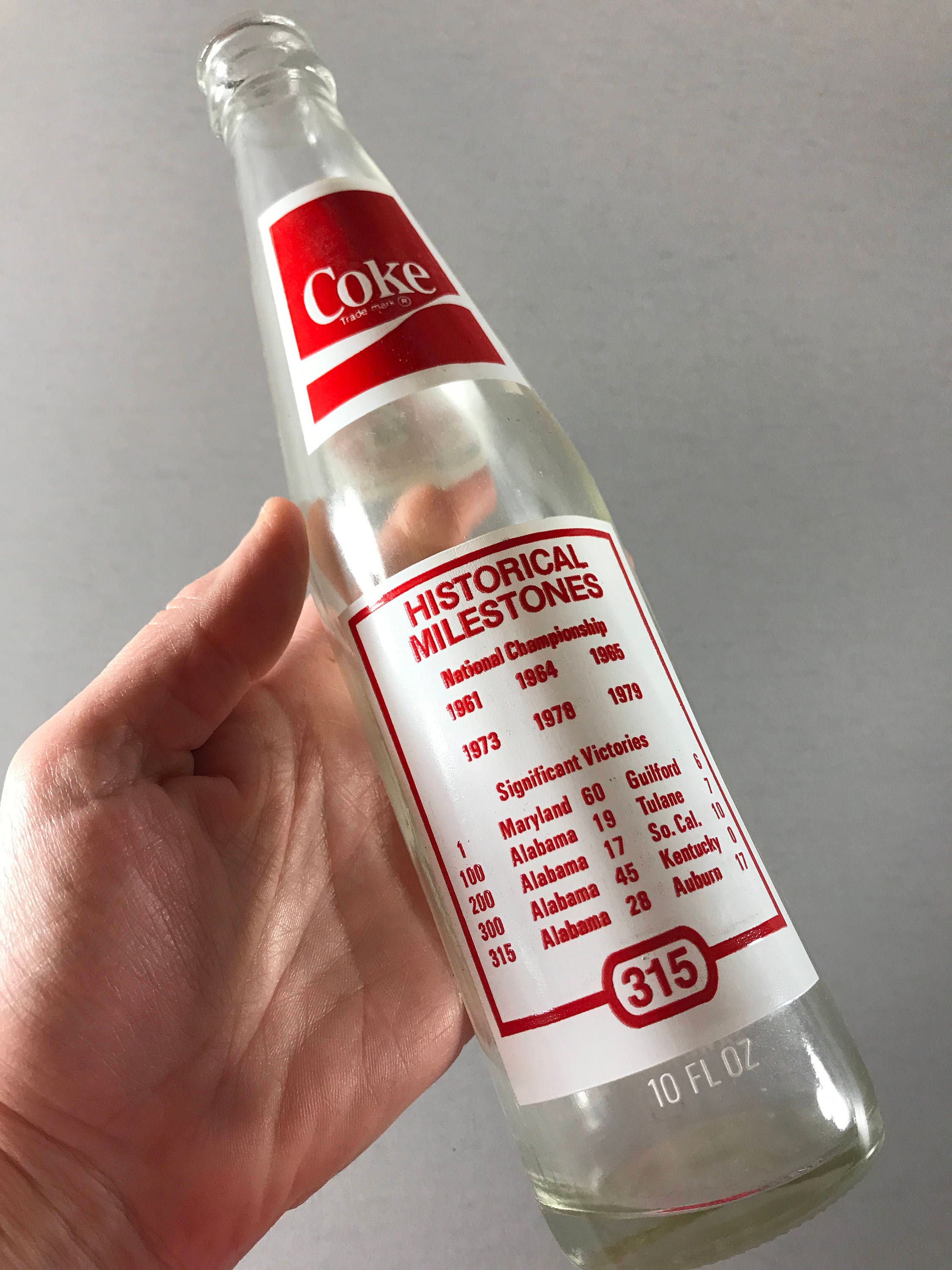 10 OZ COCA COLA COMMEMORATIVE BOTTLE - 1985 INGLES 100TH STORE OPENING