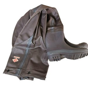 May include: Brown insulated waders with attached boots. The boots have a textured sole and the waders have a reinforced knee area. The waders are made of a durable, waterproof material and are designed for use in wet environments.