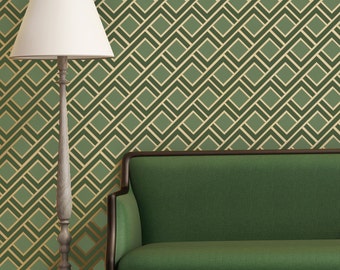 May include: A green sofa with a wooden frame sits in front of a wall with a geometric pattern of green and gold squares.