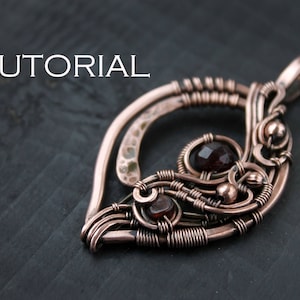 May include: A copper wire wrapped pendant featuring three dark red gemstones. The pendant is attached to a copper chain.