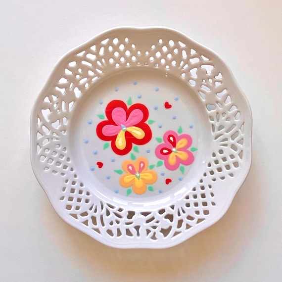 Vintage plate with cut out details, hand painted with flowers, leaves and dots. Decorative wall plate.
