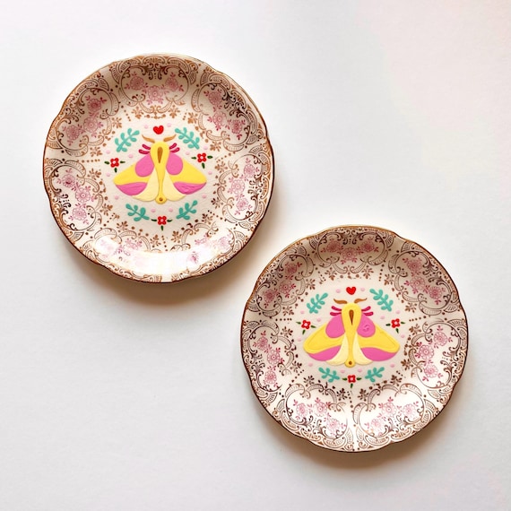 One vintage plate hand painted with a rosy maple moth. Decorative wall plate