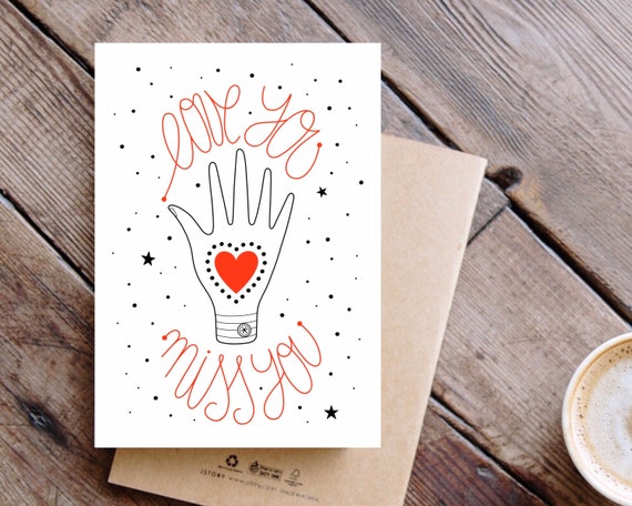 Love You, Miss You. Hand and red heart A6 greeting card.