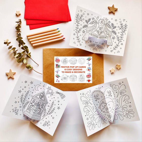 Festive pop up cards kit. 6 cosy and festive pop up card designs to colour in & make, with 6 red envelopes. Card making kit.