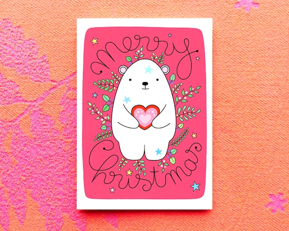 Snow bear Christmas card. Cute polar bear with winter foliage. Cute Christmas card. Pink Christmas card with a polar bear.