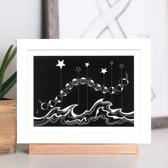 Black and white print, moon phases, stars and waves.