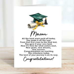 May include: A graduation card featuring a green mortarboard, diploma, and gold ribbon illustration. The card includes the name "Mason" and a congratulatory message. The text reads "Congratulations on reaching this milestone today."