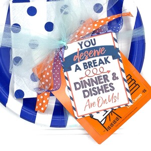 May include: A gift set featuring blue and white striped paper plates, polka dot napkins, and a gift tag that reads "You deserve a break, dinner & dishes are on us!" Tied with orange and blue ribbons.
