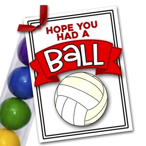 May include: A white card with black border and red ribbon says "Hope you had a ball" with a black and white volleyball graphic. The card is attached to a clear tube filled with colorful gumballs.