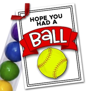 May include: A white card with black trim and red ribbon reads "Hope you had a ball". A yellow softball with red stitching is pictured on the card. A clear tube filled with colorful gumballs is next to the card.