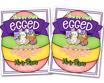 May include: Two colorful Easter egg-shaped signs with a bunny rabbit holding a basket of eggs. The signs say "You've Been Egged" and "There are 12 eggs hidden in your yard. You will find one empty egg. It's a reminder of Jesus' empty tomb. Because... He is Risen." Happy Easter, The Miller Family.