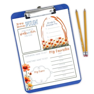 May include: A blue clipboard with a silver clip, featuring a printed worksheet with floral accents and text. The worksheet includes sections for personal reflection, such as "Words to Describe Me" and "My Favorites." Two yellow pencils with red erasers are placed on the right.