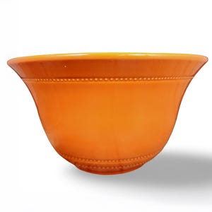May include: A vibrant orange ceramic bowl with a wide, flared rim and a smooth, glossy finish. The exterior features two distinct horizontal bands of raised, bead-like detailing encircling the upper and lower sections of the bowl's body.
