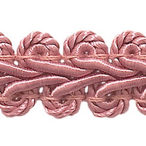 May include: A close-up of a pink braided trim with a decorative pattern. The trim is made of a soft, woven fabric and has a delicate, intricate design.