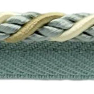 May include: Decorative trim featuring a twisted rope design in light gray, cream, and tan. Below the rope is a teal fabric with a chevron pattern. This trim is suitable for various craft and home decor projects.