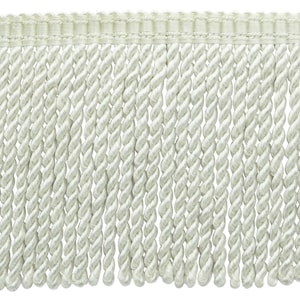 May include: White twisted fringe trim with a woven top edge. This trim is perfect for adding a touch of elegance to curtains, pillows, and other home decor projects.