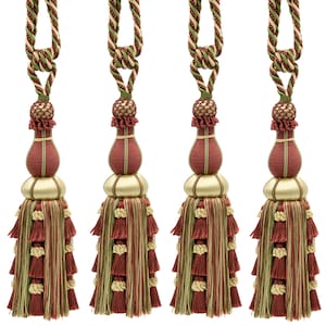 May include: Four decorative curtain tiebacks featuring a twisted cord in green, red, and cream. Each tieback has a central bulbous section, a smooth gold-toned bead, and a long, multi-layered fringe in shades of red, green, and cream.
