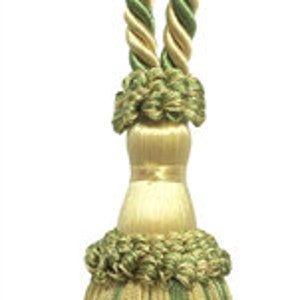 May include: A green and gold tassel with a twisted rope design. The tassel is made of a soft, silky fabric and has a long, flowing fringe.