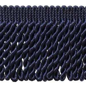 May include: A dark navy blue bullion fringe trim featuring a woven header band with a series of vertical, twisted rope-like strands hanging downwards. The trim has a consistent, uniform texture and a deep, saturated colour throughout the entire piece.