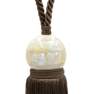 May include: A brown tassel tieback with a white mother of pearl ball. The tassel is made of a soft, silky material and has a long, flowing fringe.