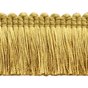 May include: Gold fringe trim with a woven top edge. The fringe is approximately 1 inch long.