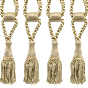 May include: Four beige tassel tiebacks with a braided rope design. The tassels are made of a soft, woven fabric and have a fringed edge.