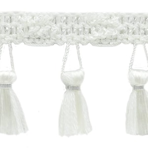 May include: White fringe trim with a delicate crochet design and small tassels. The fringe is approximately 2.5 cm in length.