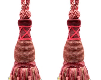 May include: Two red and gold tassel tiebacks with pom-poms. The tassels are made of a woven fabric and have a beaded detail.