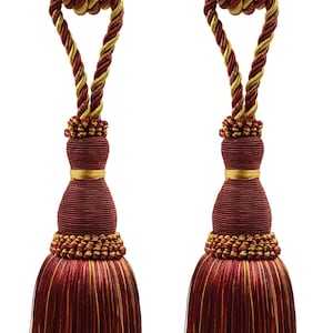 May include: Two burgundy and gold tassel tiebacks with a braided rope design. The tassels are made of a soft, fringed fabric.