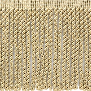 May include: A close-up of a beige twisted fringe trim. The fringe is made of a soft, woven fabric and has a subtle sheen.
