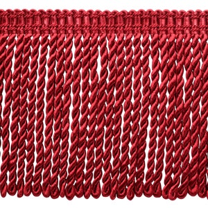 May include: Red twisted fringe trim. The fringe is made of a soft, silky material and has a subtle sheen.